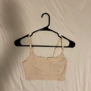 It is a cream sport bra size small